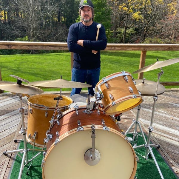 Jeff Berlin posing with drumkit